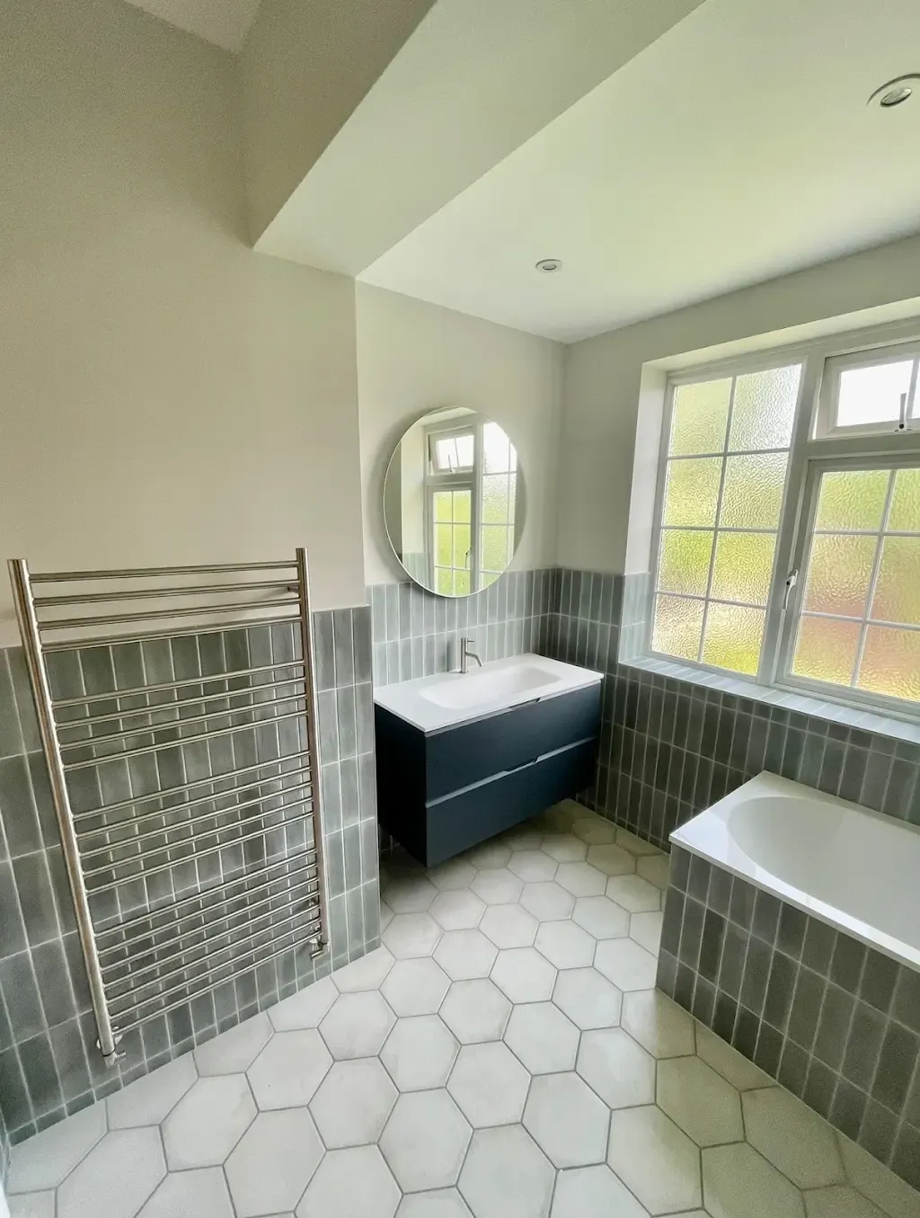 Grey bathroom, hexagon floor by Prestige Tiling